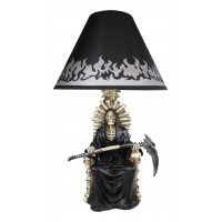 The scary wise grim reaper holding a scythe sitting on a desk lamp