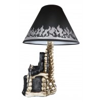 The scary wise grim reaper holding a scythe sitting on a desk lamp